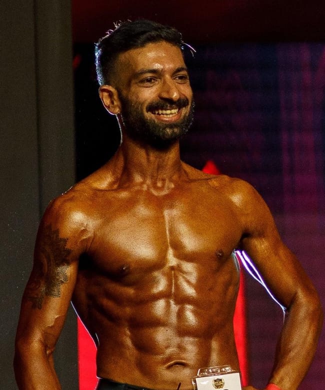 Ratan competing on stage as a natural drug-tested athlete